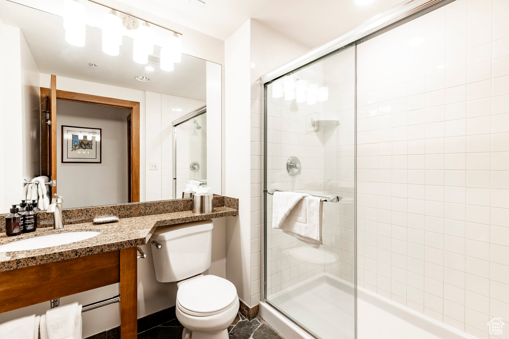 Full bath featuring a stall shower and vanity