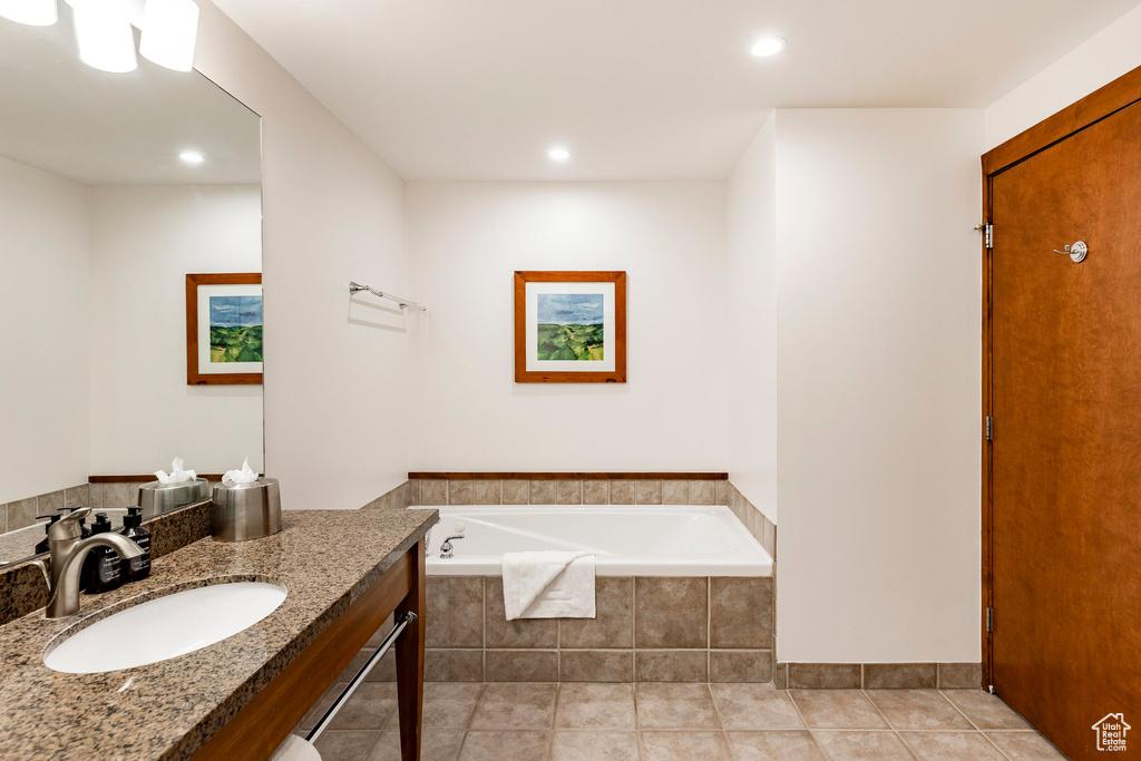 Full bathroom featuring vanity, a bath, tile patterned floors, and recessed lighting
