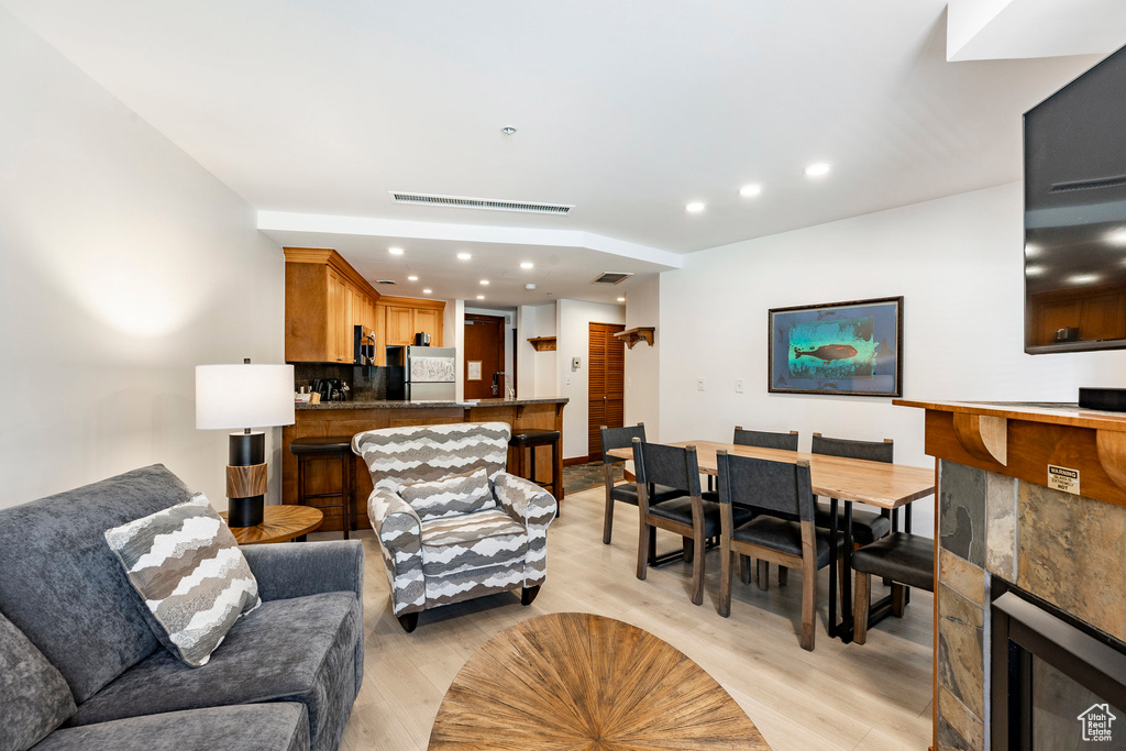 Living room with recessed lighting and light wood-type flooring