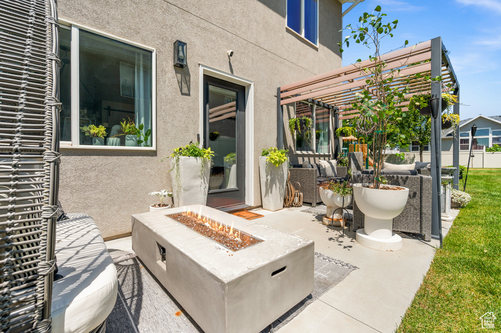 View of patio / terrace featuring a pergola and an outdoor living space with a fire pit