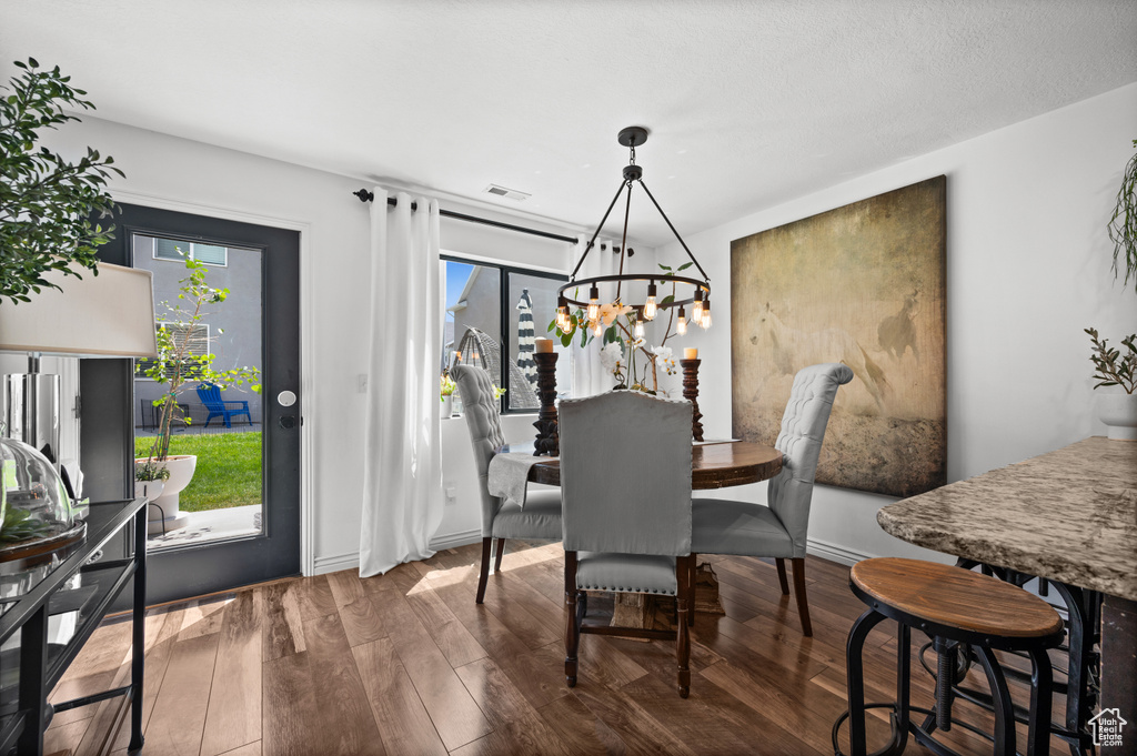 Dining area featuring a chandelier and wood finished floors