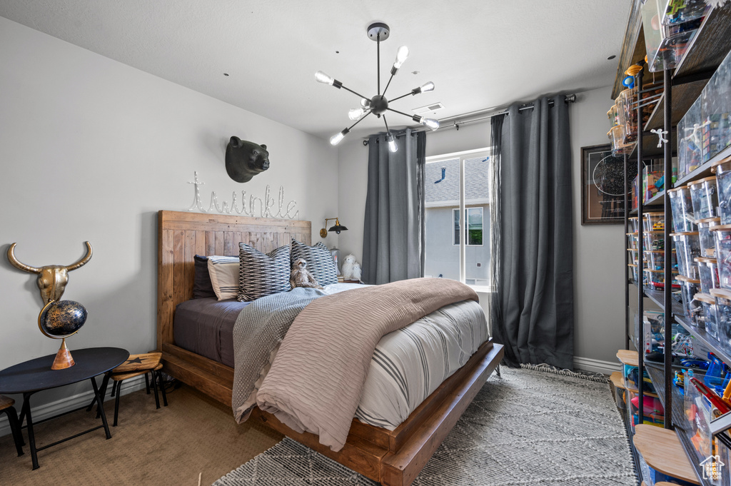 Bedroom with a chandelier and baseboards