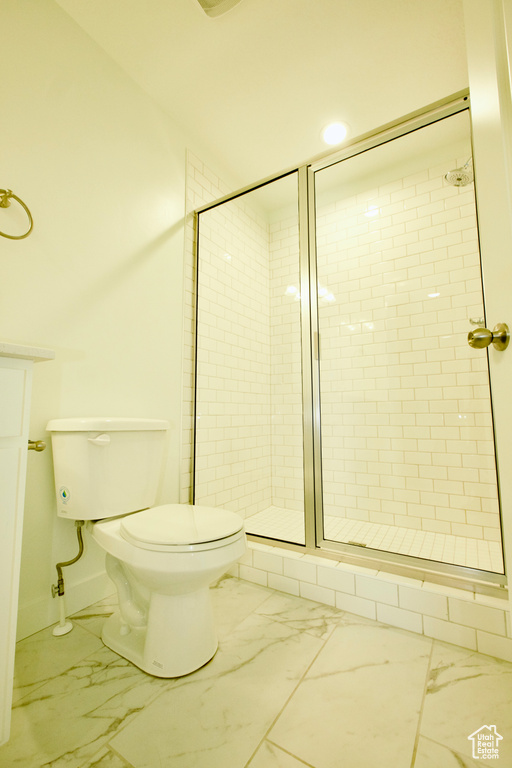 Full bathroom featuring marble look tiles and a stall shower
