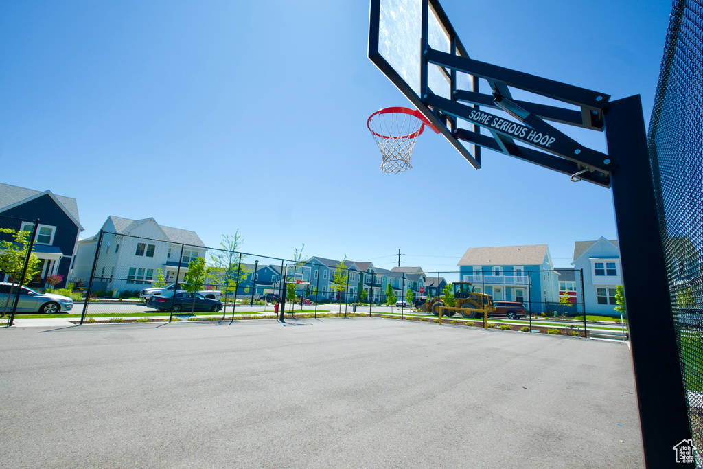 View of basketball court with a residential view