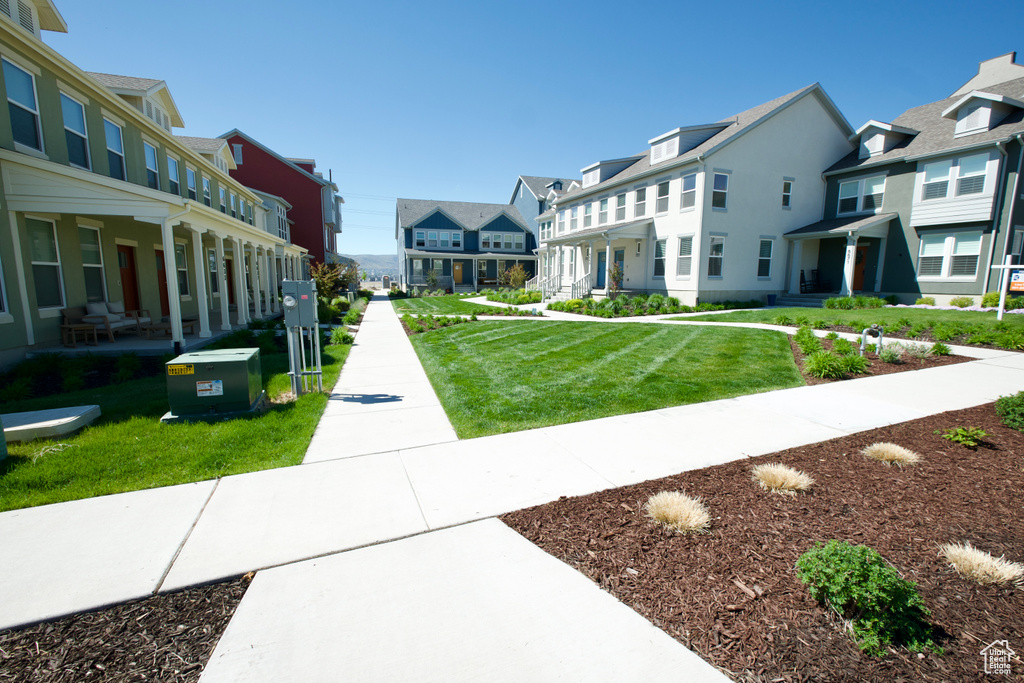 Surrounding community featuring a residential view and a yard
