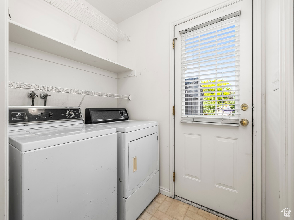 Washroom featuring washing machine and dryer