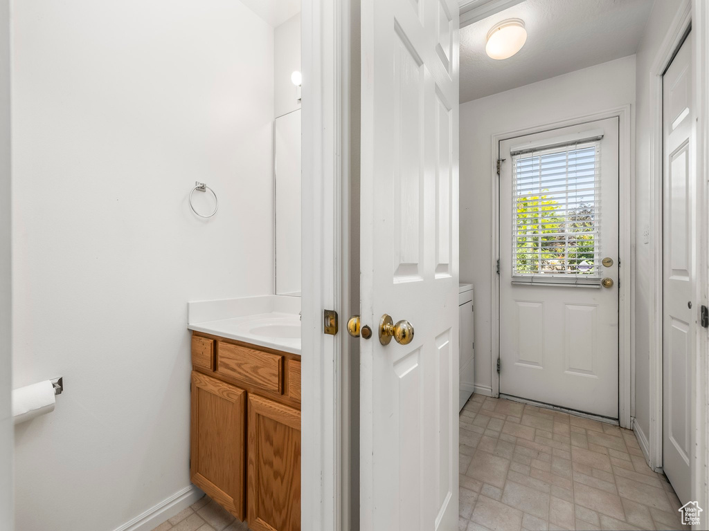 Entryway with baseboards and brick patterned floors