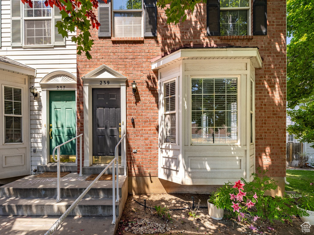 Entrance to property featuring brick siding