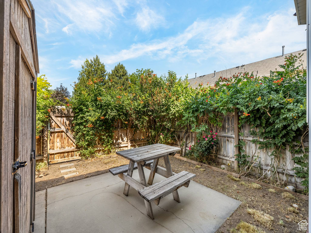 Fenced backyard with a patio area and outdoor dining space