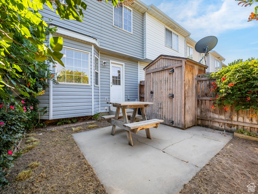 View of patio featuring a storage unit