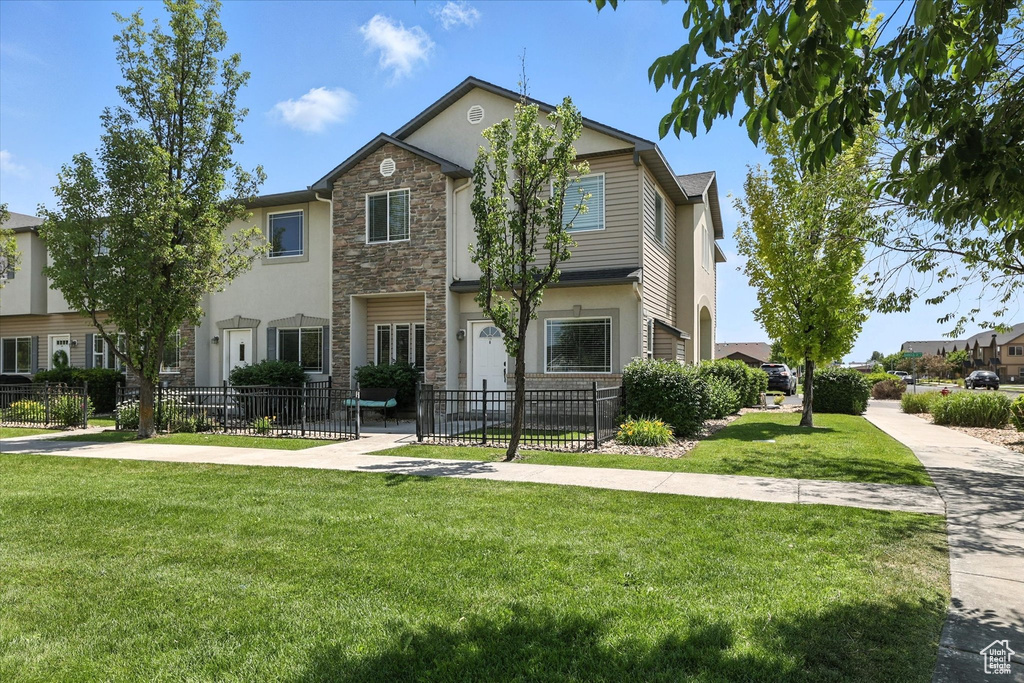 View of front of property featuring stone siding and stucco siding