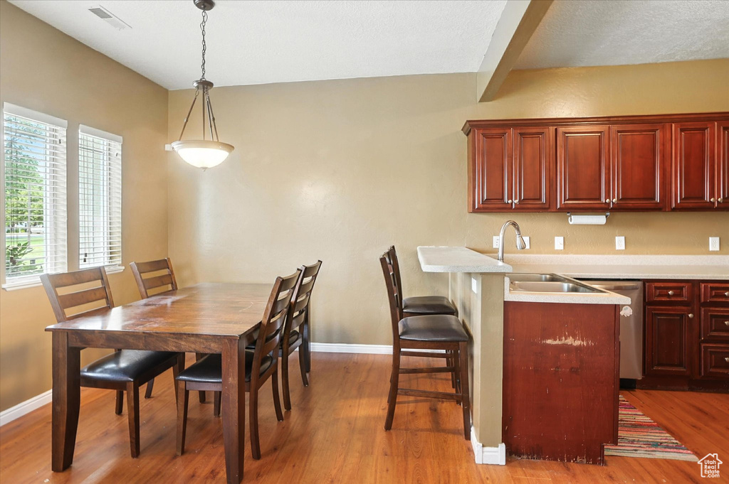 Dining room with light wood-style floors and baseboards