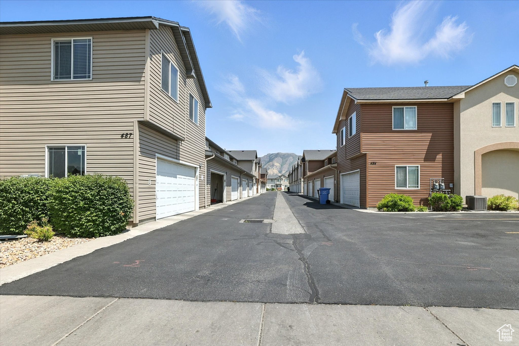 View of asphalt road featuring a residential view