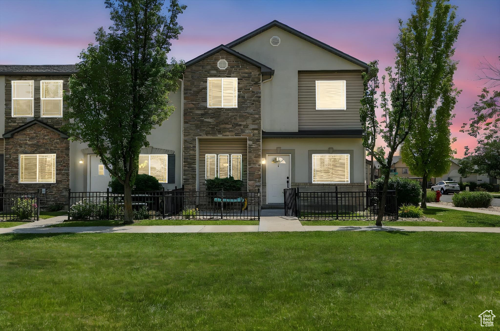 View of front of house with stone siding and stucco siding