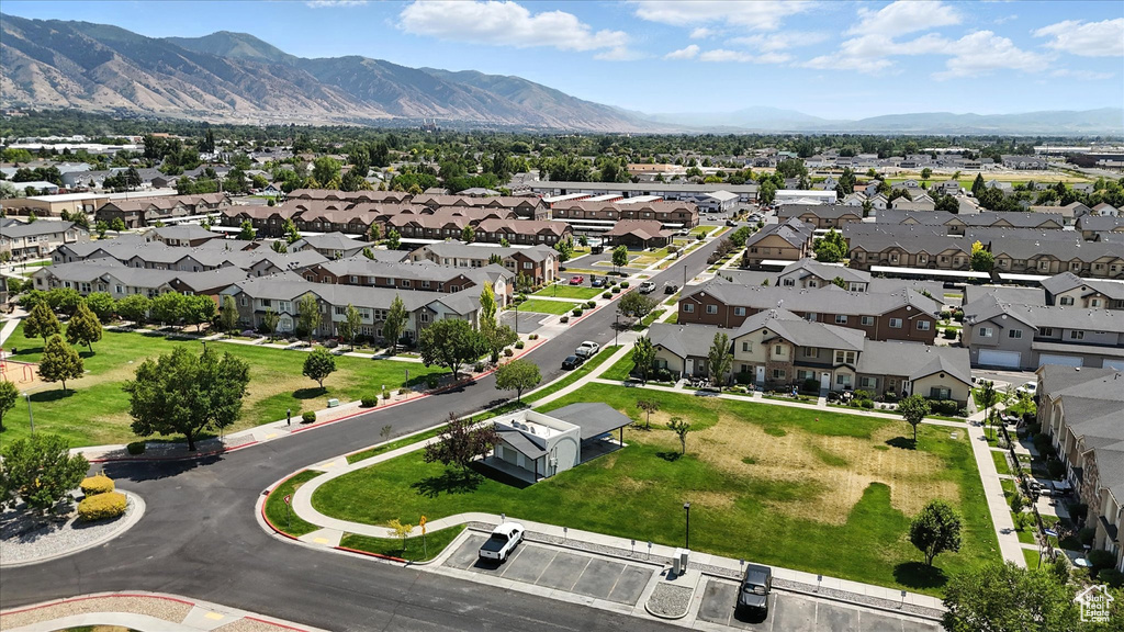 Aerial overview of property's location with a mountainous background and nearby suburban area