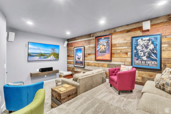 Carpeted home theater featuring wooden walls and recessed lighting