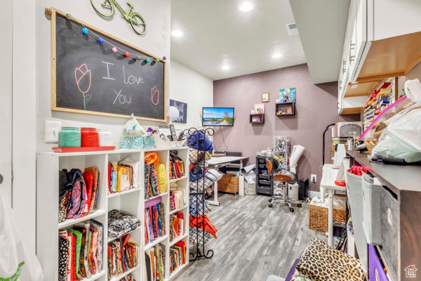 Playroom with wood finished floors and recessed lighting