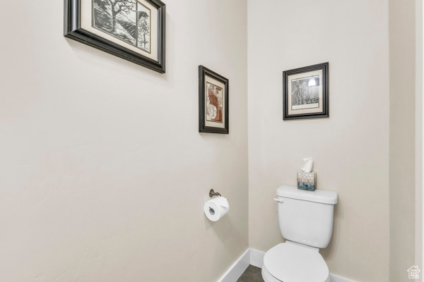 Bathroom with toilet and baseboards