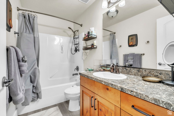 Full bathroom featuring shower / tub combo with curtain and vanity