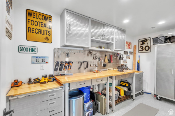 Kitchen with decorative backsplash, wooden counters, recessed lighting, and gray cabinetry