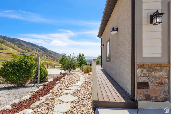 View of property exterior featuring a mountain view and stucco siding