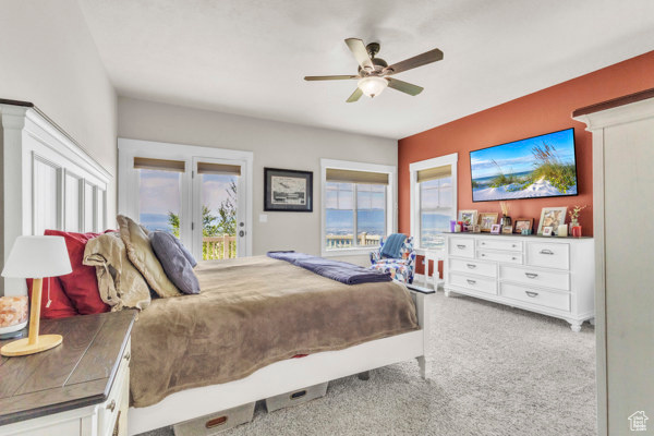 Carpeted bedroom with access to outside and a ceiling fan