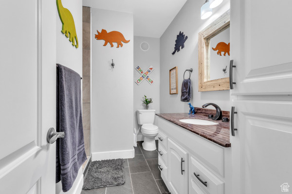Bathroom with vanity, tile patterned floors, and a walk in shower