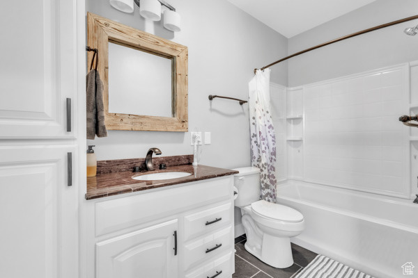 Full bathroom featuring vanity, shower / tub combo, and tile patterned floors