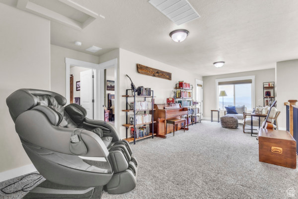 Sitting room with carpet and baseboards
