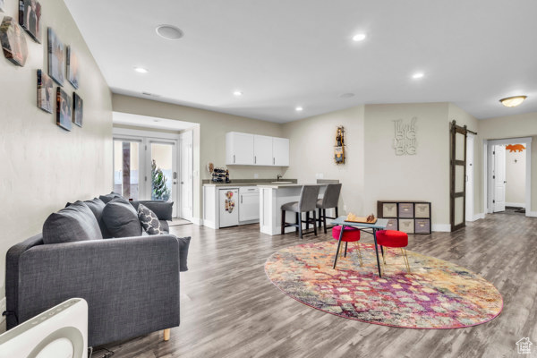 Living room featuring wood finished floors and recessed lighting