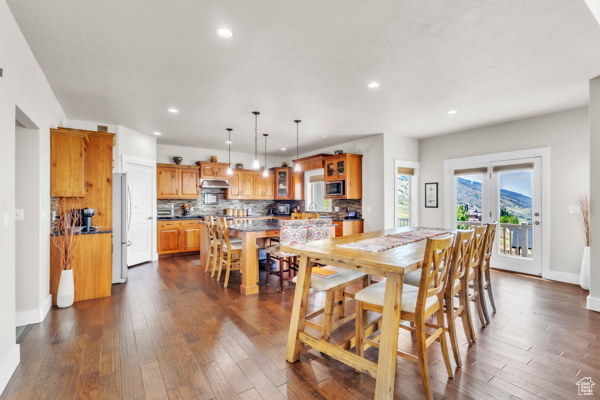 Dining room featuring recessed lighting and dark wood-type flooring