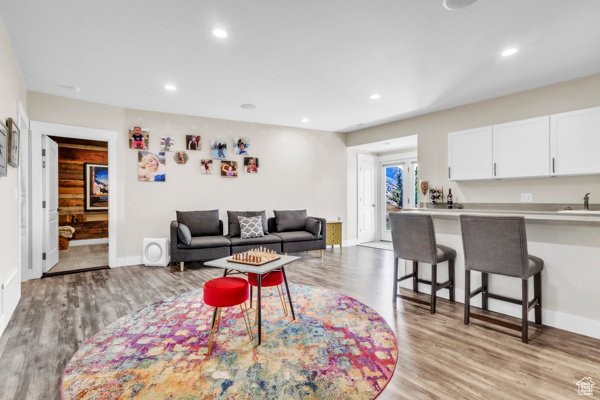 Living room featuring light wood finished floors and recessed lighting