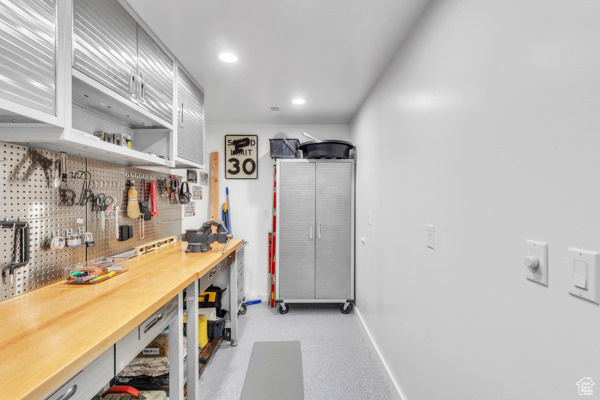 Interior space with a workshop area and recessed lighting
