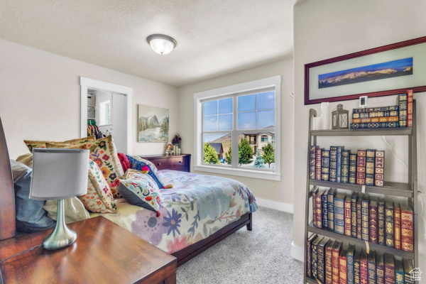 Carpeted bedroom featuring baseboards