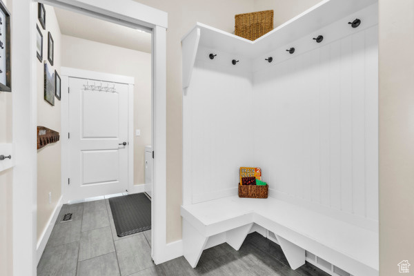 Mudroom with tile patterned flooring and baseboards