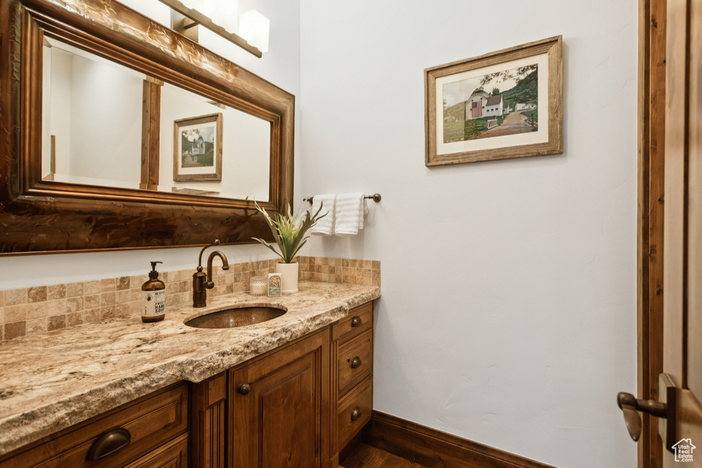 Bathroom featuring vanity and wood finished floors