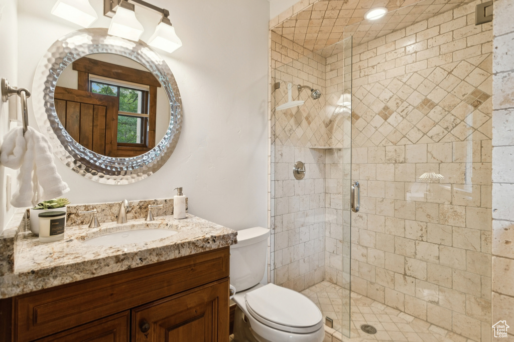 Full bath with vanity and a shower stall