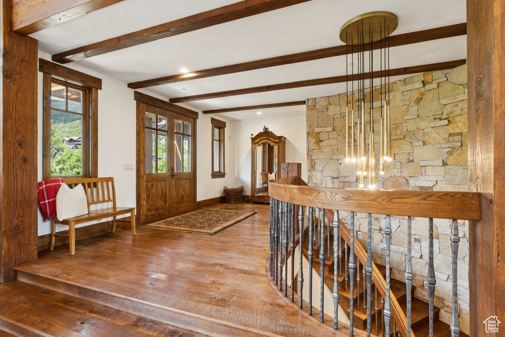 Foyer entrance featuring hardwood / wood-style floors and beamed ceiling