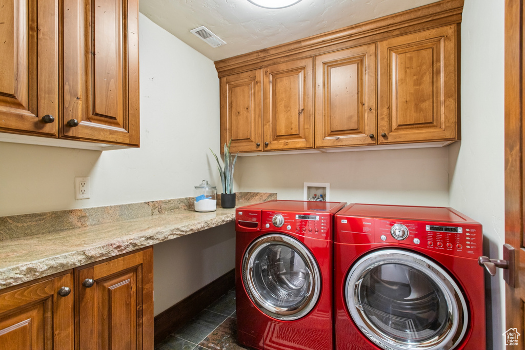Washroom featuring washing machine and clothes dryer and cabinet space