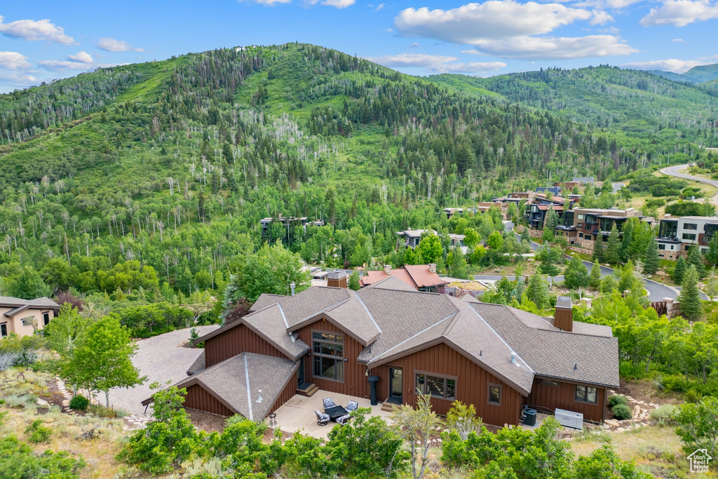 View from above of property featuring a heavily wooded area and mountains