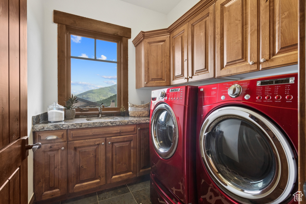 Washroom featuring cabinet space and washing machine and dryer