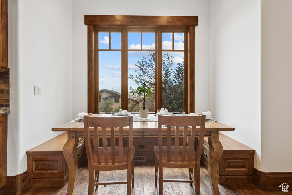 Dining room with healthy amount of natural light and wood finished floors