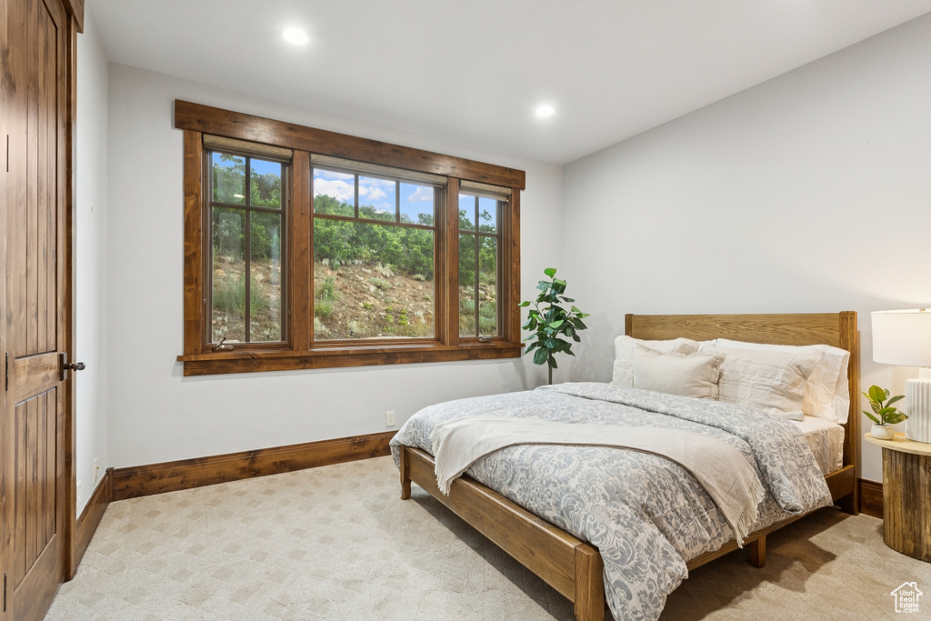 Carpeted bedroom with recessed lighting