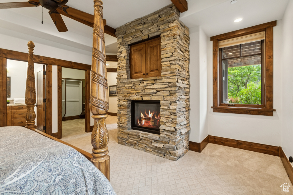 Bedroom with baseboards and a stone fireplace
