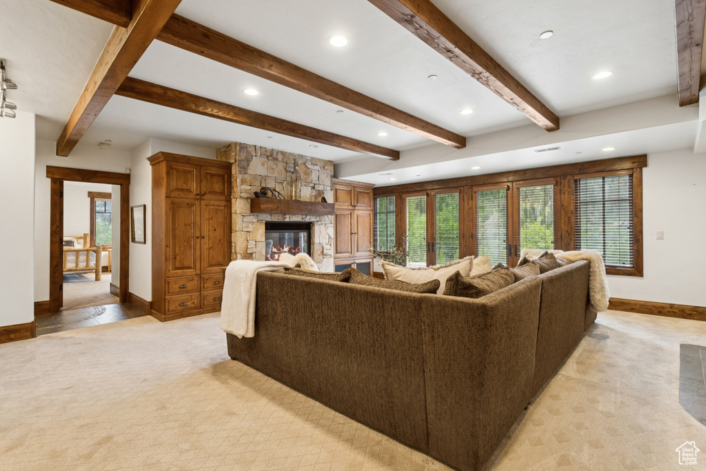 Living room with recessed lighting, light carpet, a fireplace, and beam ceiling