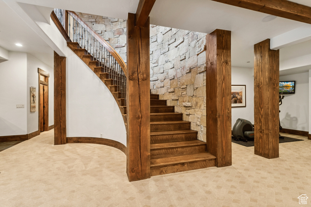 Stairs with carpet flooring and recessed lighting