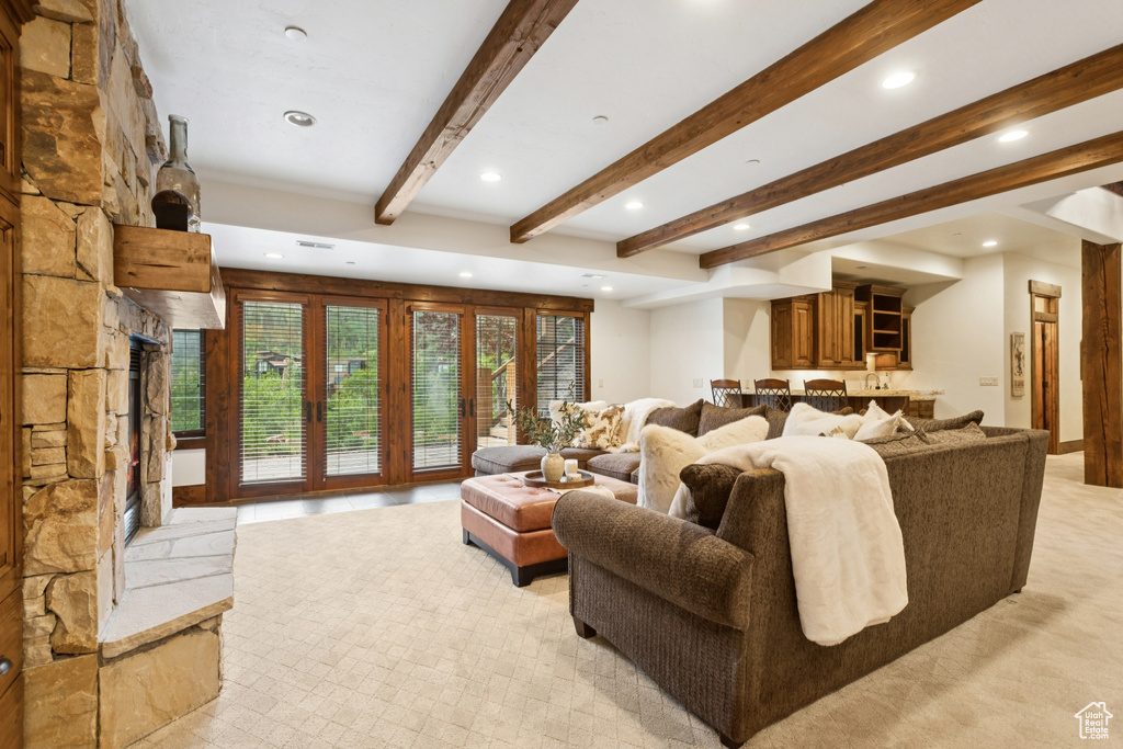 Living room featuring beamed ceiling, recessed lighting, and light carpet