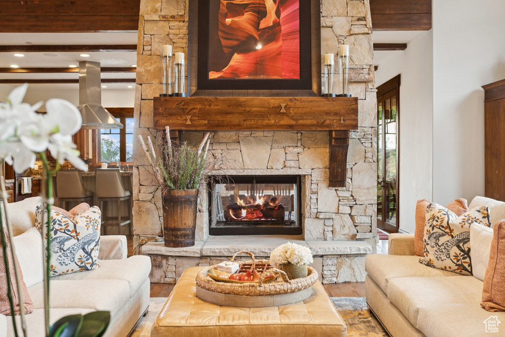 Living room with a fireplace, wood finished floors, beamed ceiling, healthy amount of natural light, and recessed lighting