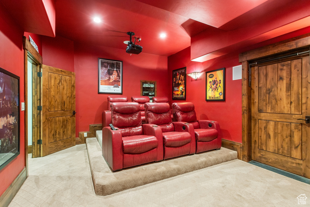 Home theater featuring carpet floors, recessed lighting, and a barn door