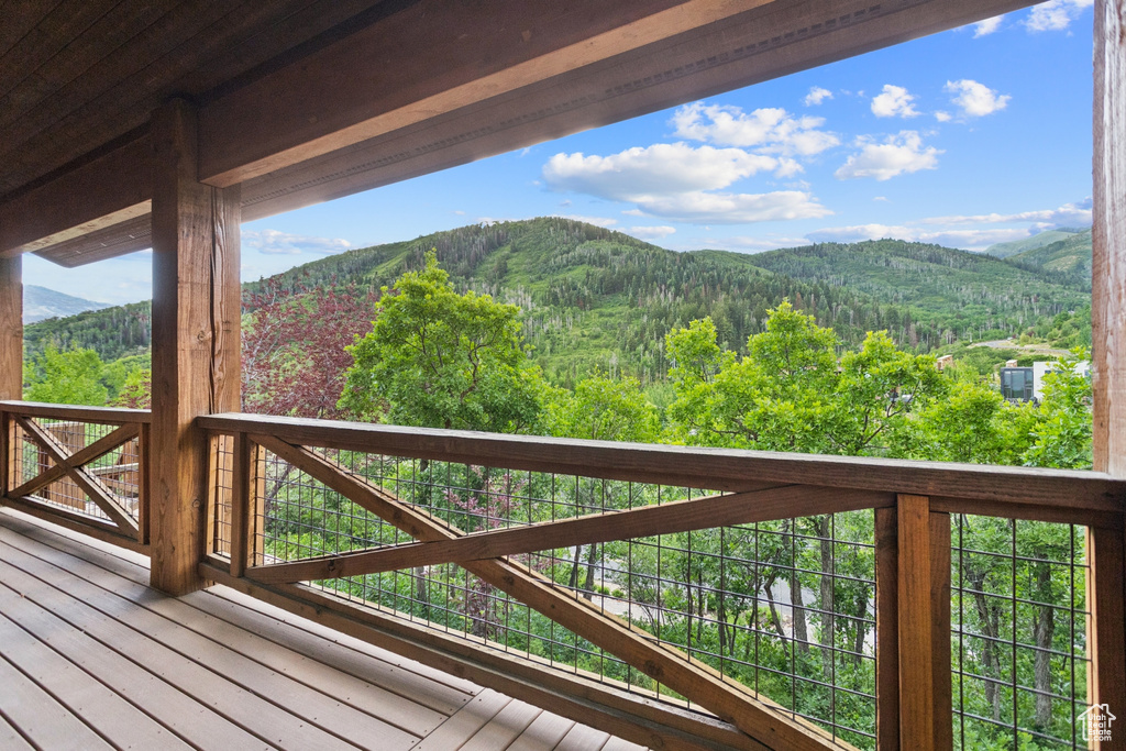 Deck featuring a mountain view and a forest view
